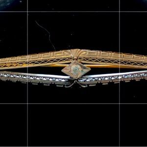 2 1/4 inch gold and platinum stick pi n with central diamond. Vintage c1910.